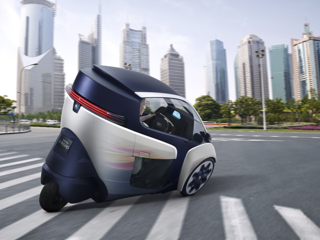 Toyota's i-ROAD is a fully-enclosed, two-seater, three-wheeled, fully-electric, Personal Mobility Vehicle (PMV)