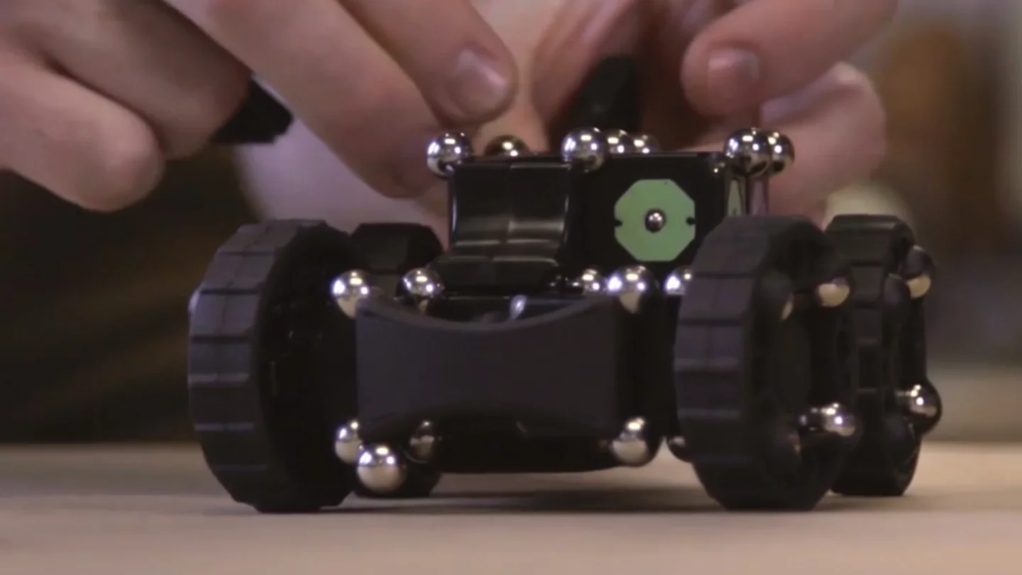 A carbon steel ball bearing/neodymium rare earth magnet connection system provides plenty of flexibility