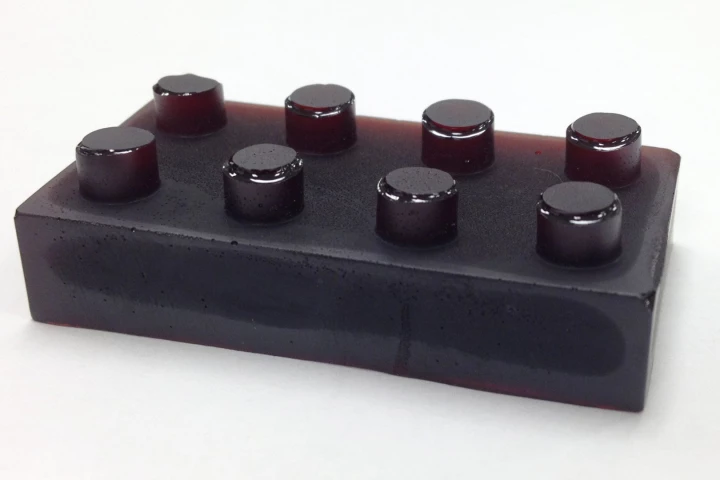 Sulfur-limonene polymer is a plastic made from citrus peel (here shown molded into the shape of a plastic building block) that can both detect and absorb mercury pollution