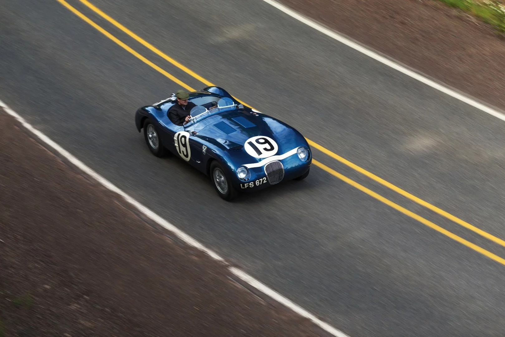 There were just 53 C-Type Jaguars built. Three lightweight works cars (of which this car is one), and a run of 50 cars to satisfy customer demand after the factory cars finished first, second and fourth in the 1953 Le Mans 24 Hour event. The biggest difference to the competition were the disc brakes. Endurance racing was born to demonstrate reliability and validate new automotive technologies for the masses and just as it has done more recently with hybrid and diesel drivetrains, Le Mans heralded the coming of age of a new braking technology with this car and its works siblings. The winning C-type was the first to average more than 100 mph for the 24 Hours of Le Mans (105.8 mph, 170 km/h), and this car, which finished fourth, also broke the ton, averaging 104 mph (167 km/h). Equally at home in any of the world’s finest concours or vintage rallies, this car represents a landmark in Jaguar history.