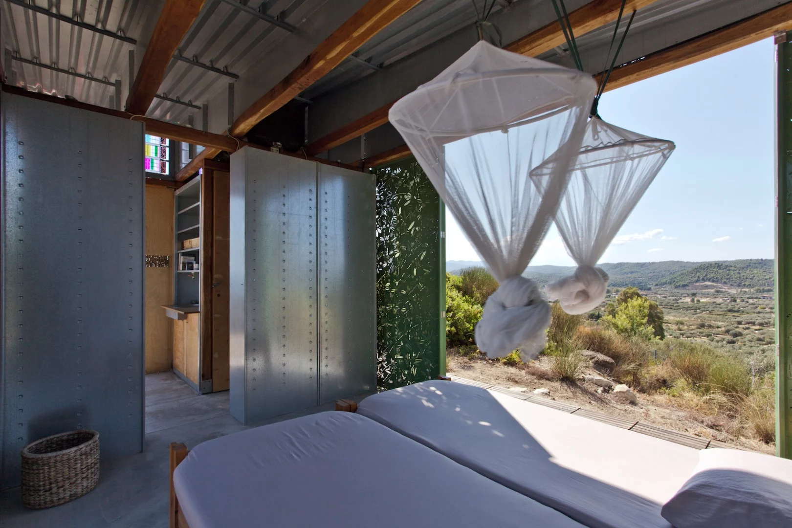 The Olive Tree House's bedroom opens up to the outside