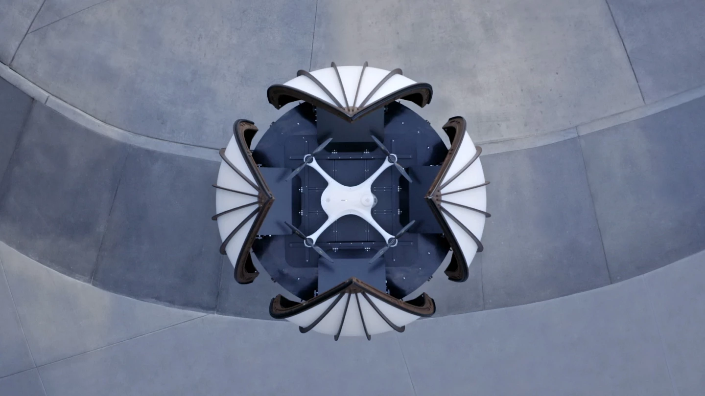 The roof of the Matternet Station opens like a flower, allowing the delivery drone to rise from the pad and fly off to its destination