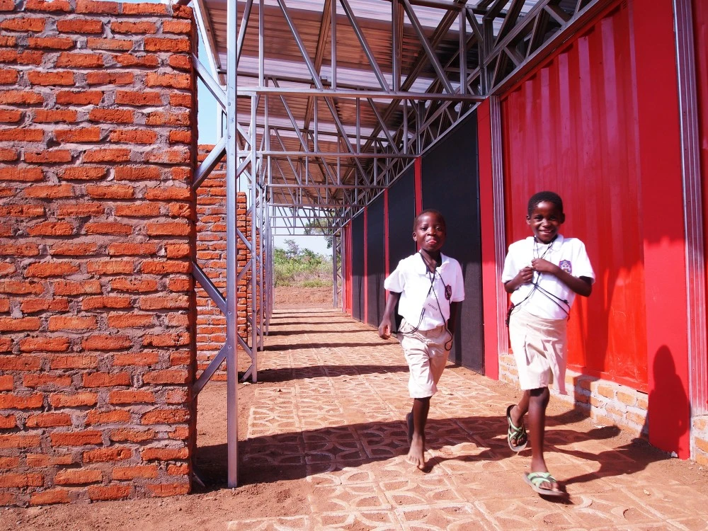 The containers were modified and a lightweight steel supporting frame and metal roof were added (Photo: Architecture for a change)