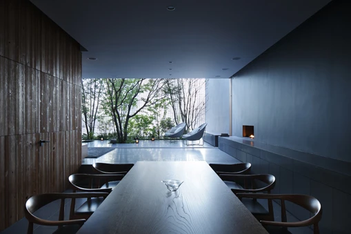 The glass facade faces the busy road and shows-off the tree filled courtyard in the space behind it (Image: Hiroshi Nakamura & NAP)
