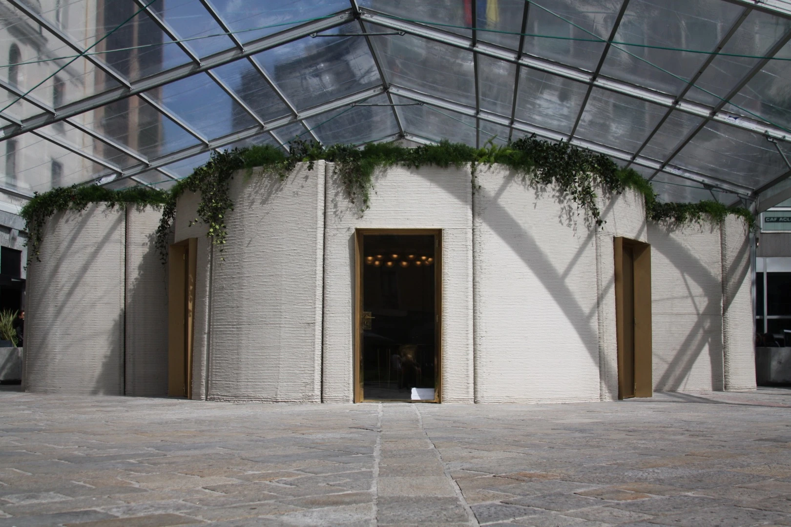 A cement mixture was extruded from a nozzle layer by layer to build up 3D Housing 05's walls, before the doors, windows and such were finished by humans