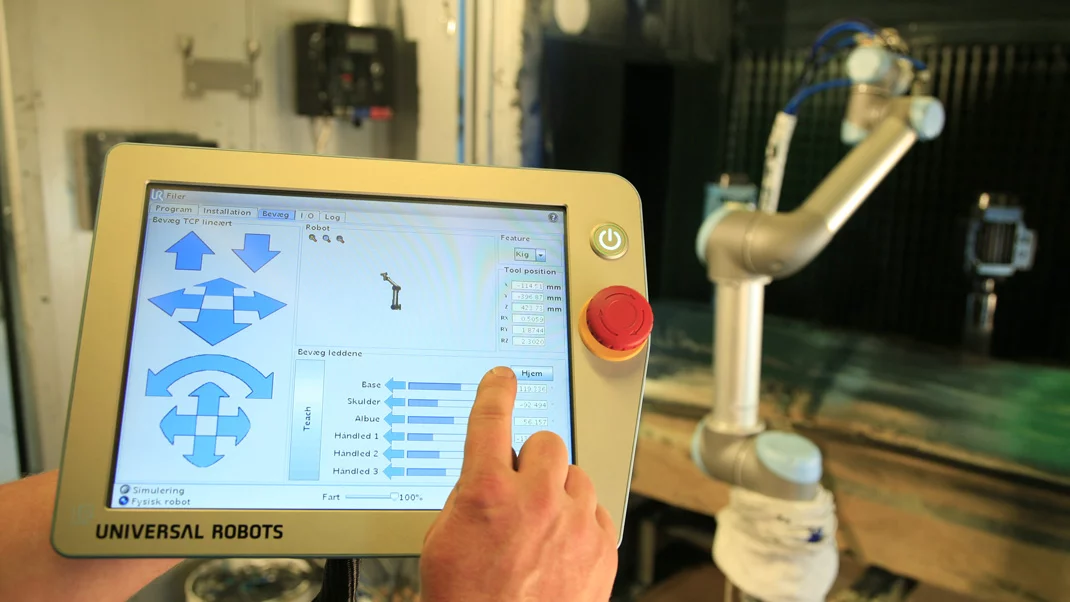 A new factory robot arm from Universal Robots is programmed using a simple GUI on an accompanying tablet