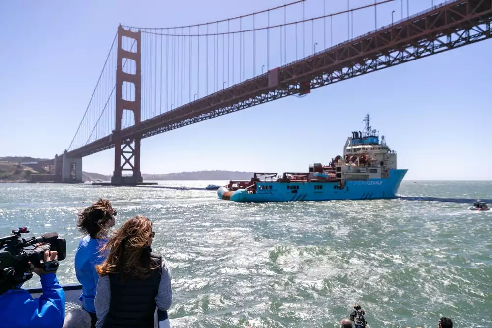 Ocean Cleanup CEO Boyan Slat watches on as his cleanup system is towed toward the Great Pacific Garbage Patch