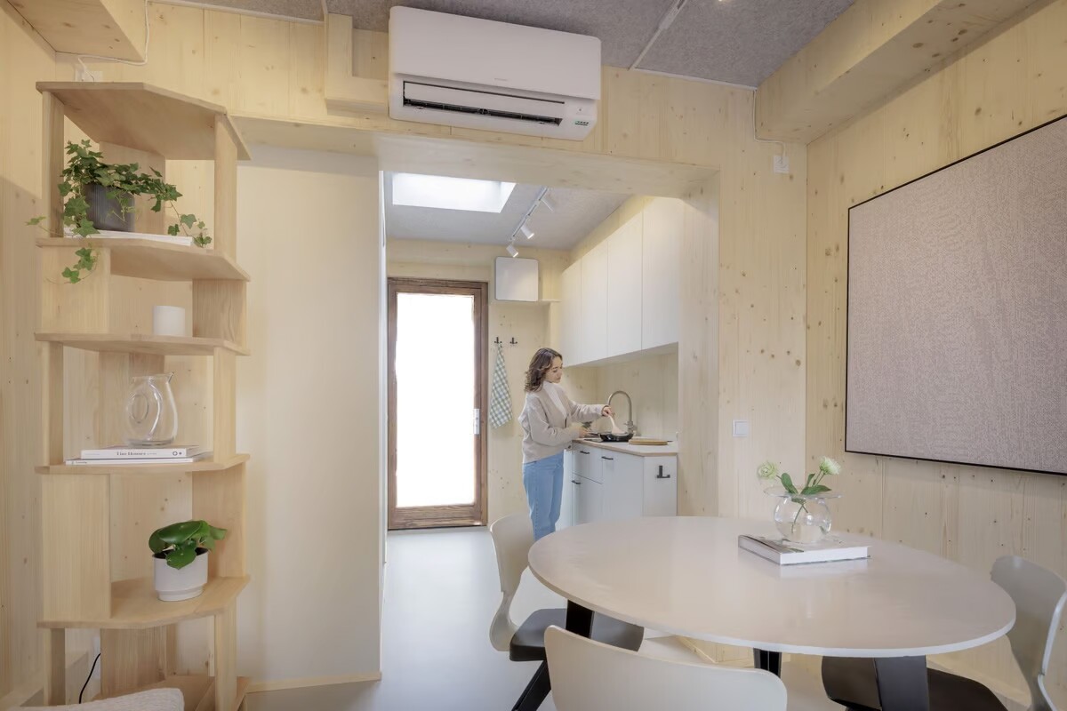 The Nestle features a wooden interior with a kitchenette, bathroom, and sleeping and living areas
