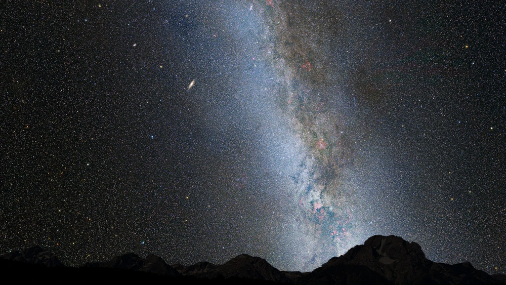 This is a nighttime image of our Milky Way galaxy, which includes a view of M31, that lies 2.5 million light-years distant and looks like a faint spindle, several times the diameter of the full Moon (Image: NASA / STScI)