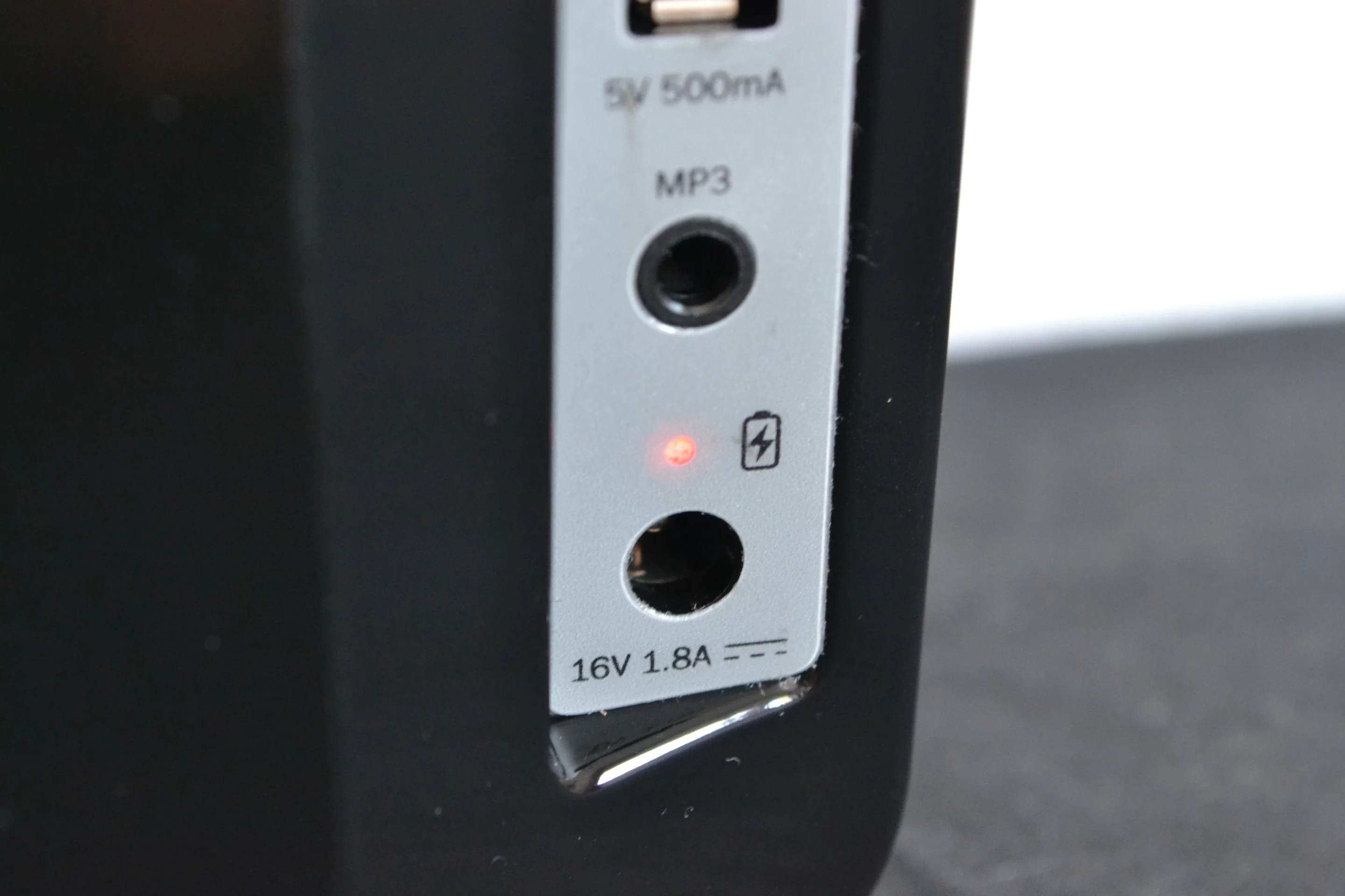 There's an LED status indicator above the power port that glows red when the battery is almost out of juice