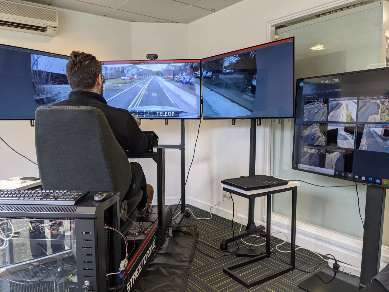 The tele-operator sees live vision through cameras on the car, and drives it using a racing game-like setup