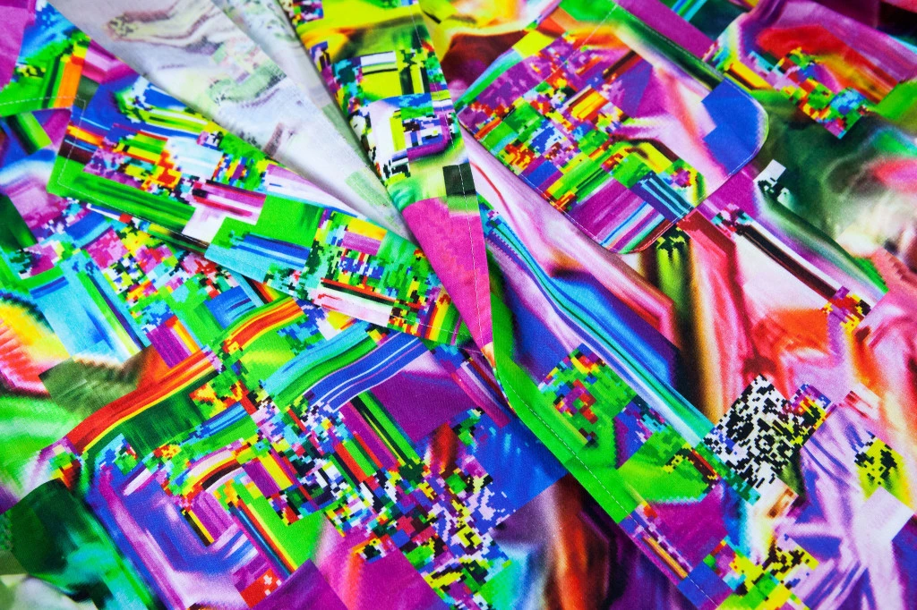 The Glitch Coat by Nukeme is a glitch design printed onto a plastic lab coat
