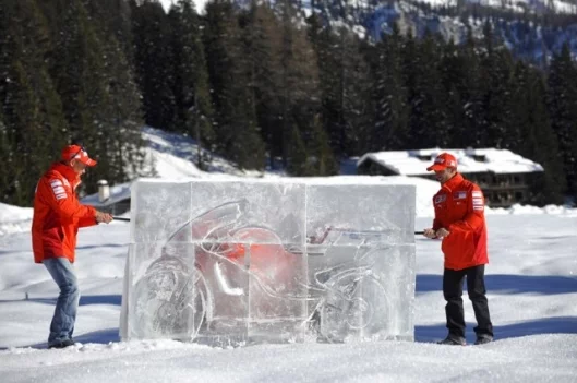 Melandri and Casey Stoner get set to unveil the new sponsorship signage on the bike