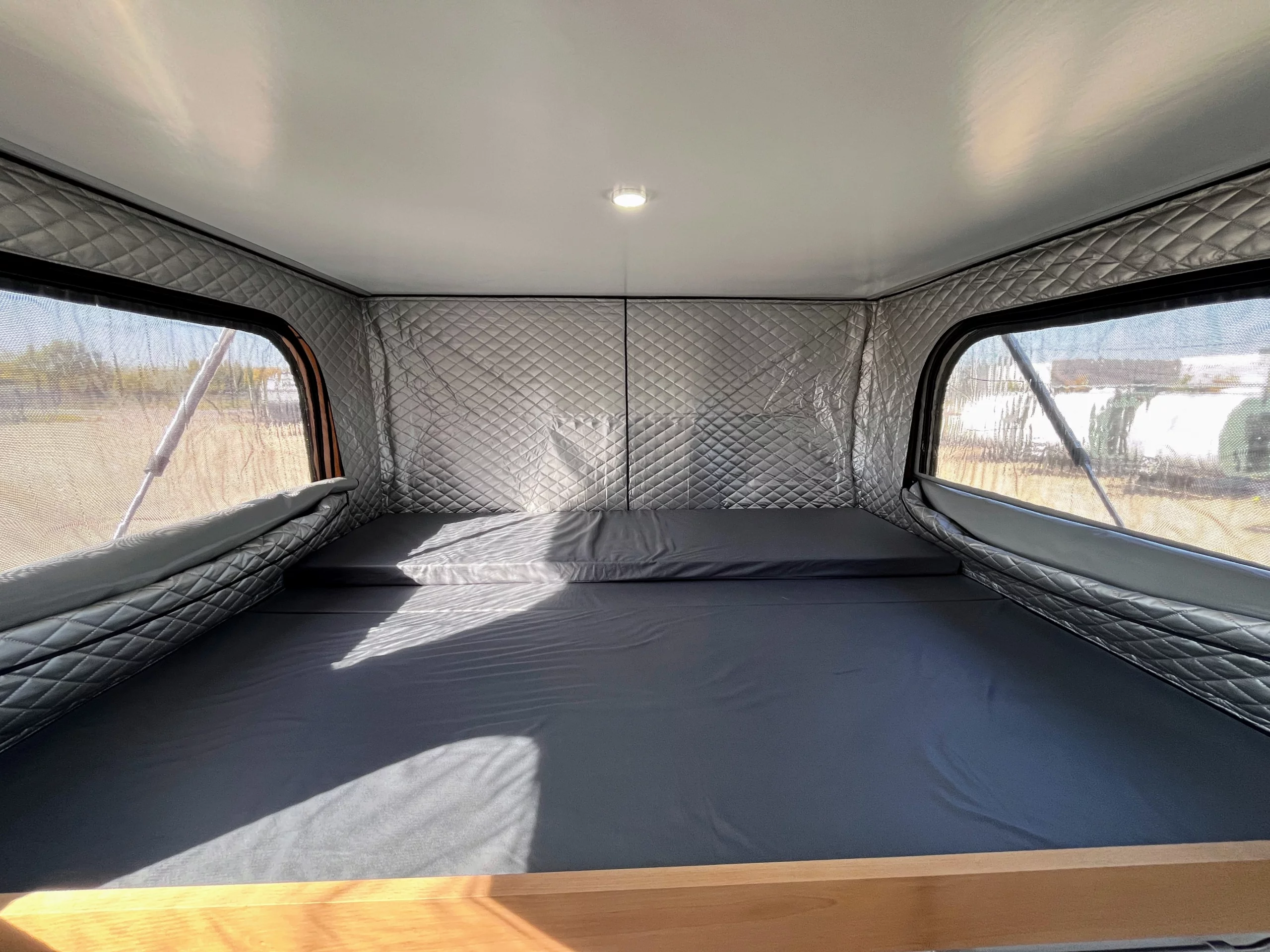 The bed slides forward into the alcove during the day (note the extra cushion at the top)