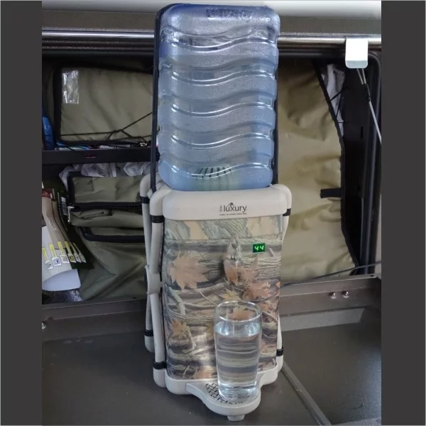 The Outdoor Extreme Water Cooler plugs into a 12 V battery to chill water to 43 degrees F