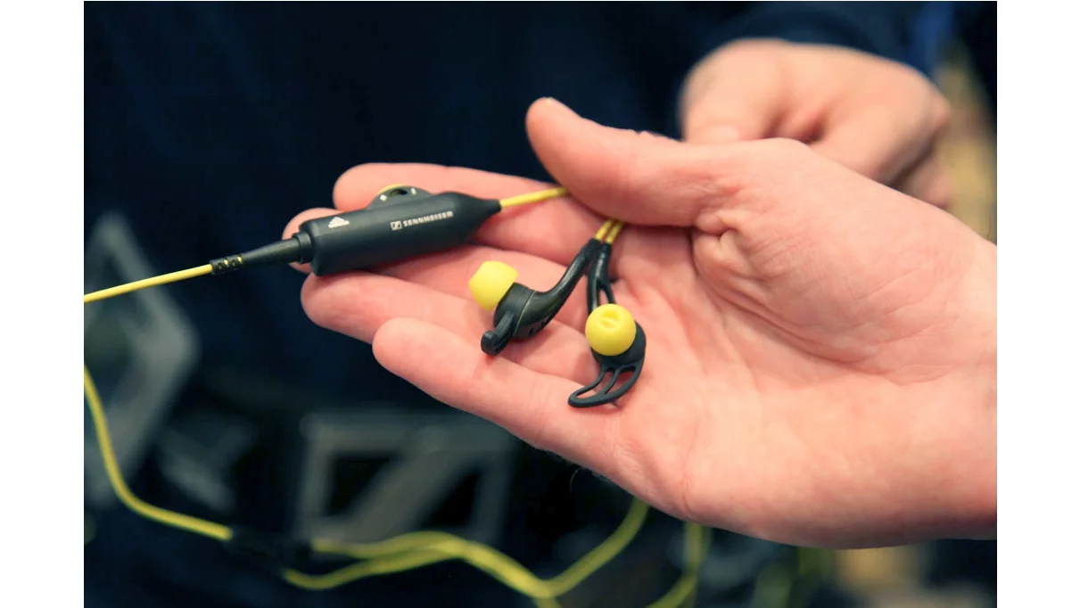 Sennheiser/Adidas CX 680 Sports ear-canal headphones showing the "ear fin" and volume-control extension cable