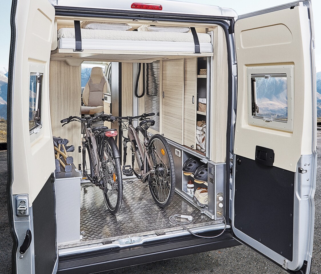 The lower bed removes and the upper bed lifts electrically to clear out a full garage for bikes and other gear