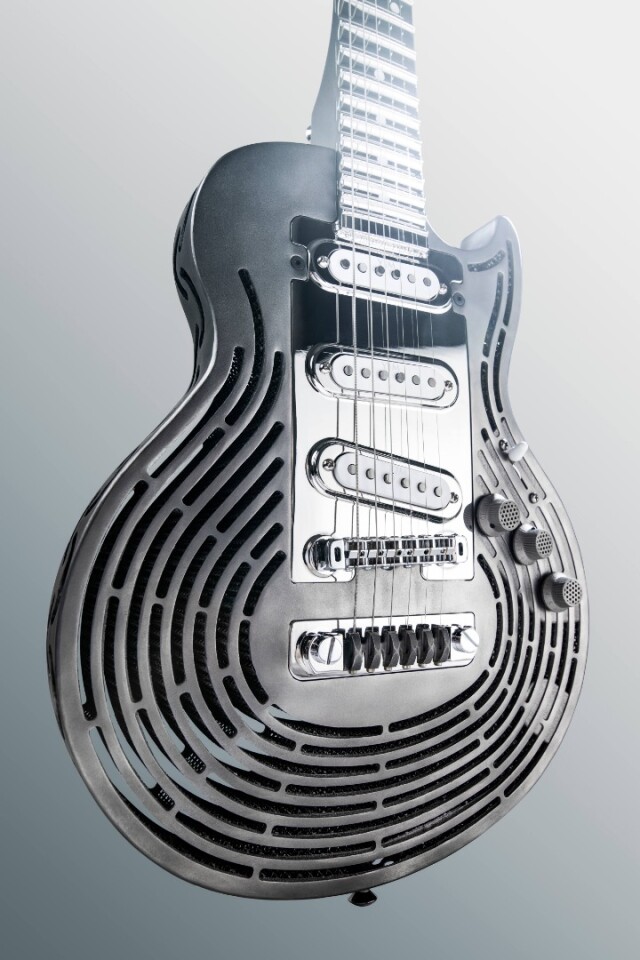 The roughly Les Paul-shaped titanium body of the Smash-Proof Guitar is 3D-printed