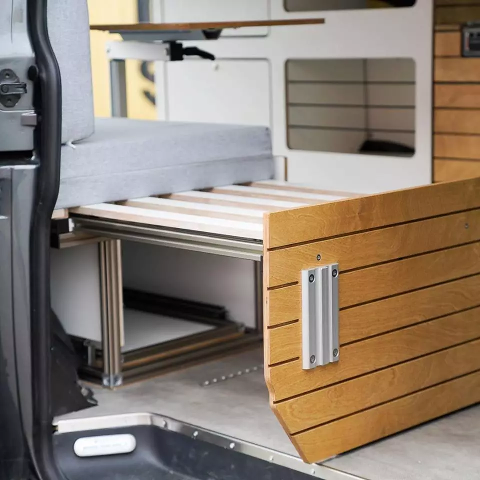This individualized van includes a small sofa that expands into a single-sleeper bed