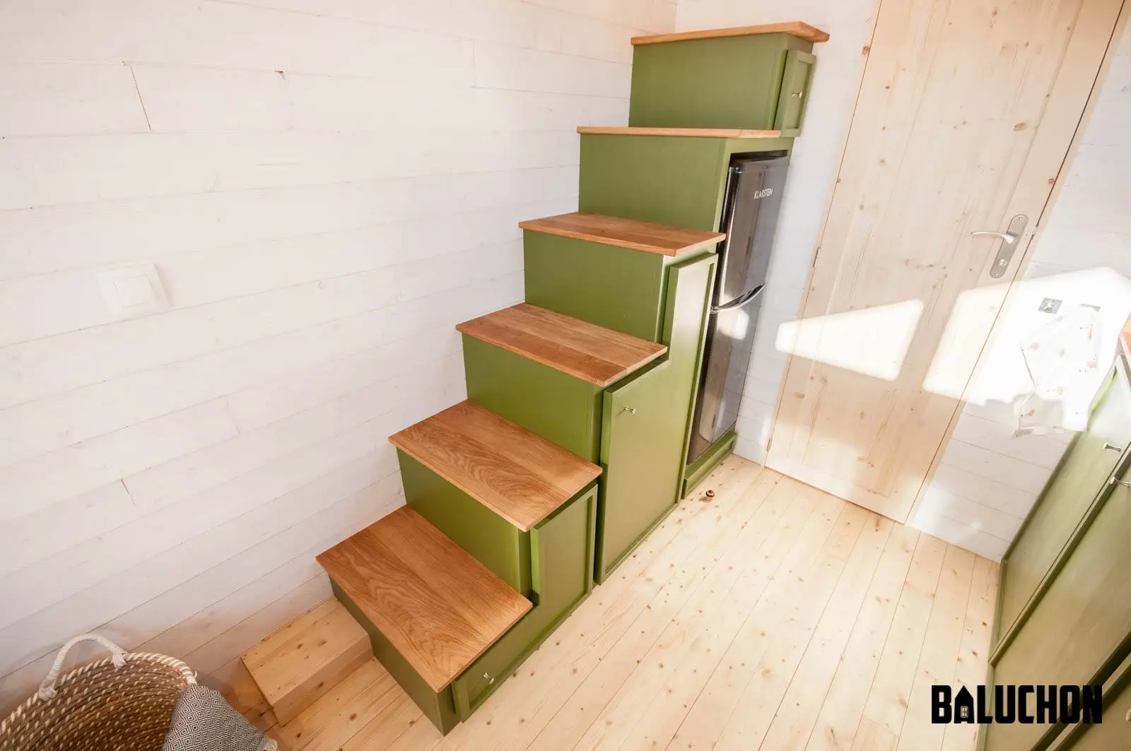 The Epona's storage-integrated staircases houses a fridge/freezer