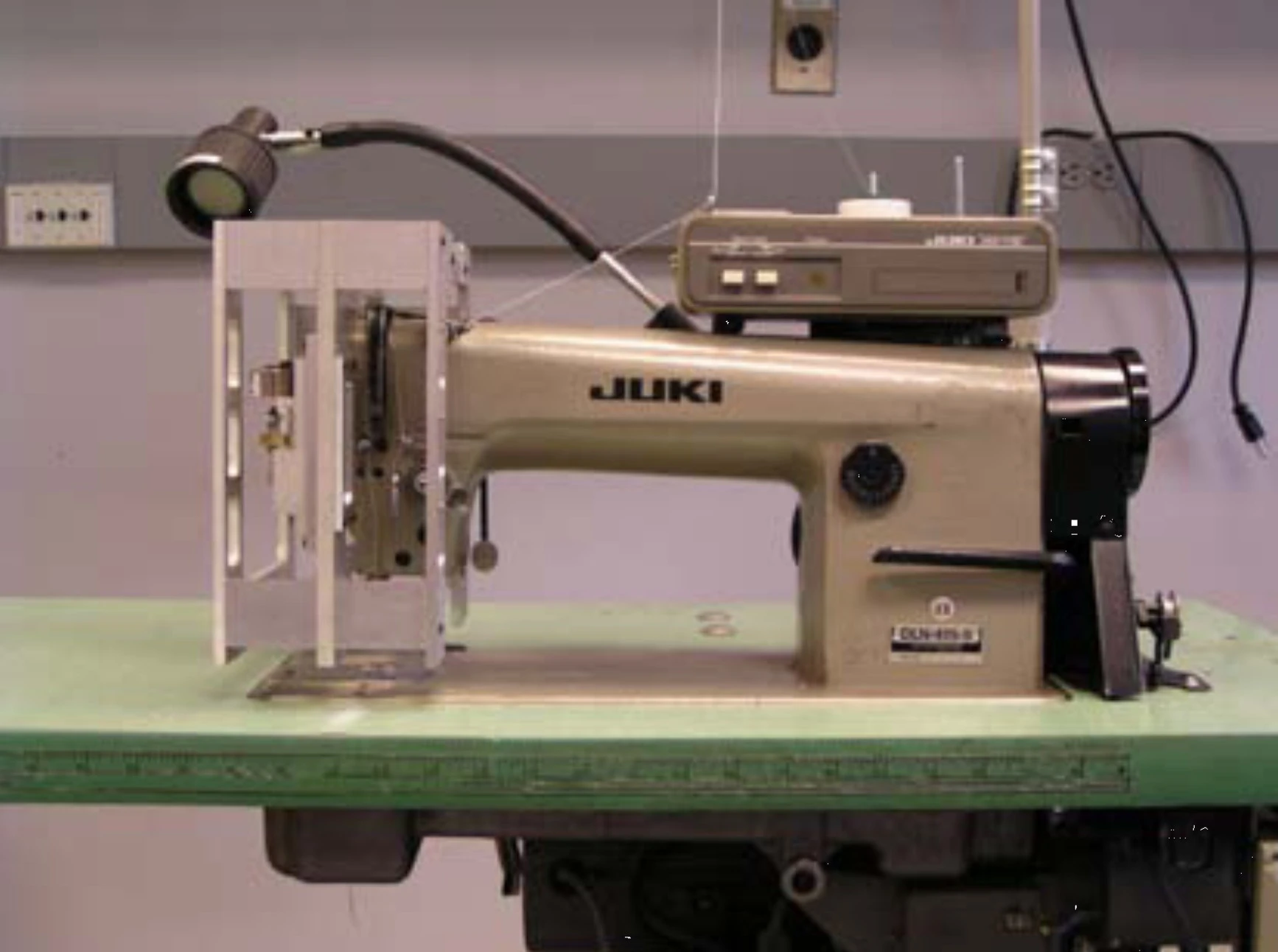 A prototype sewing machine with modified robotic servo head