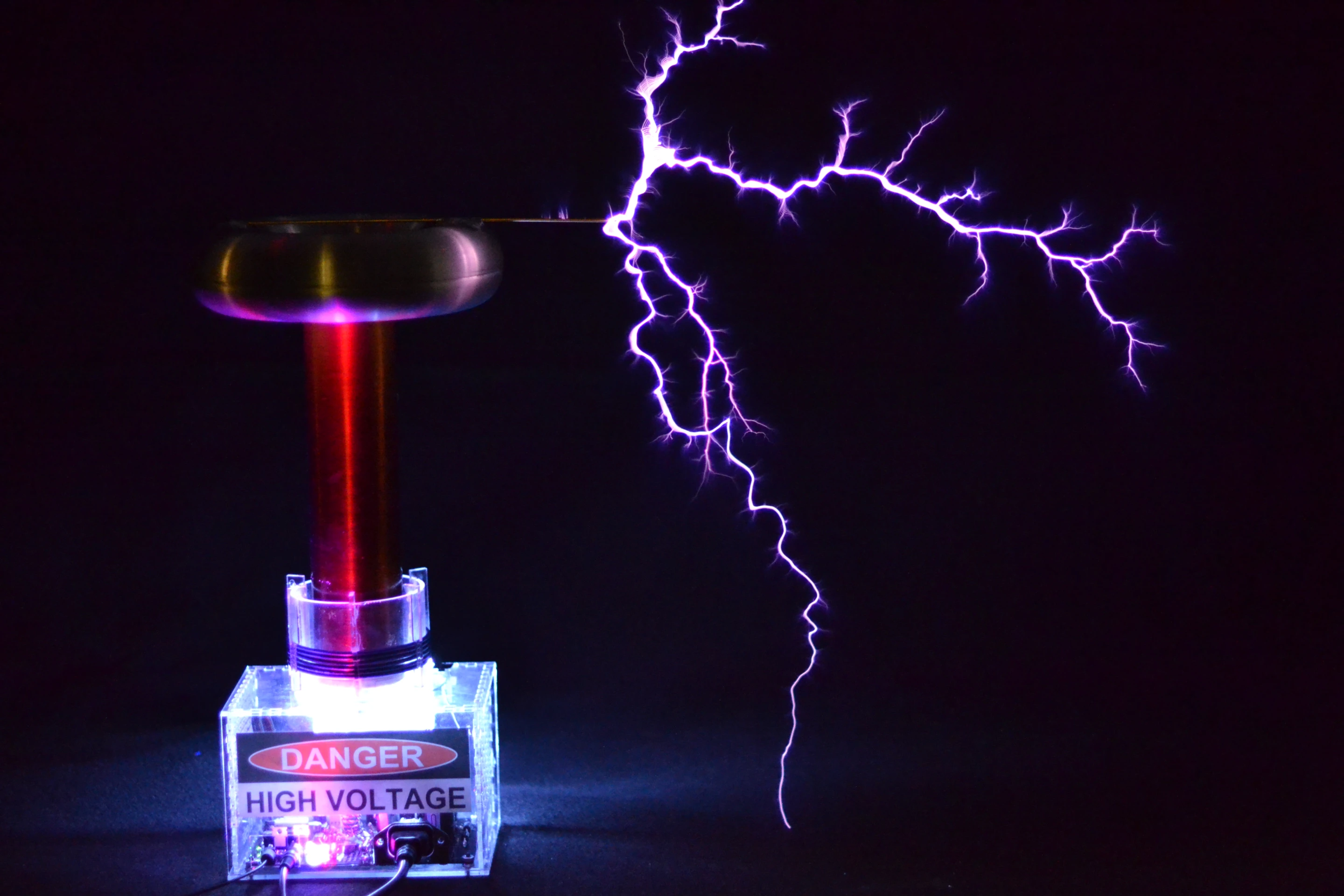 A custom interrupter modulates the electric arc, creating pressure waves that sound like musical notes