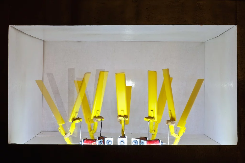 Close up of the hand clap robots placed in the MR-808's frame