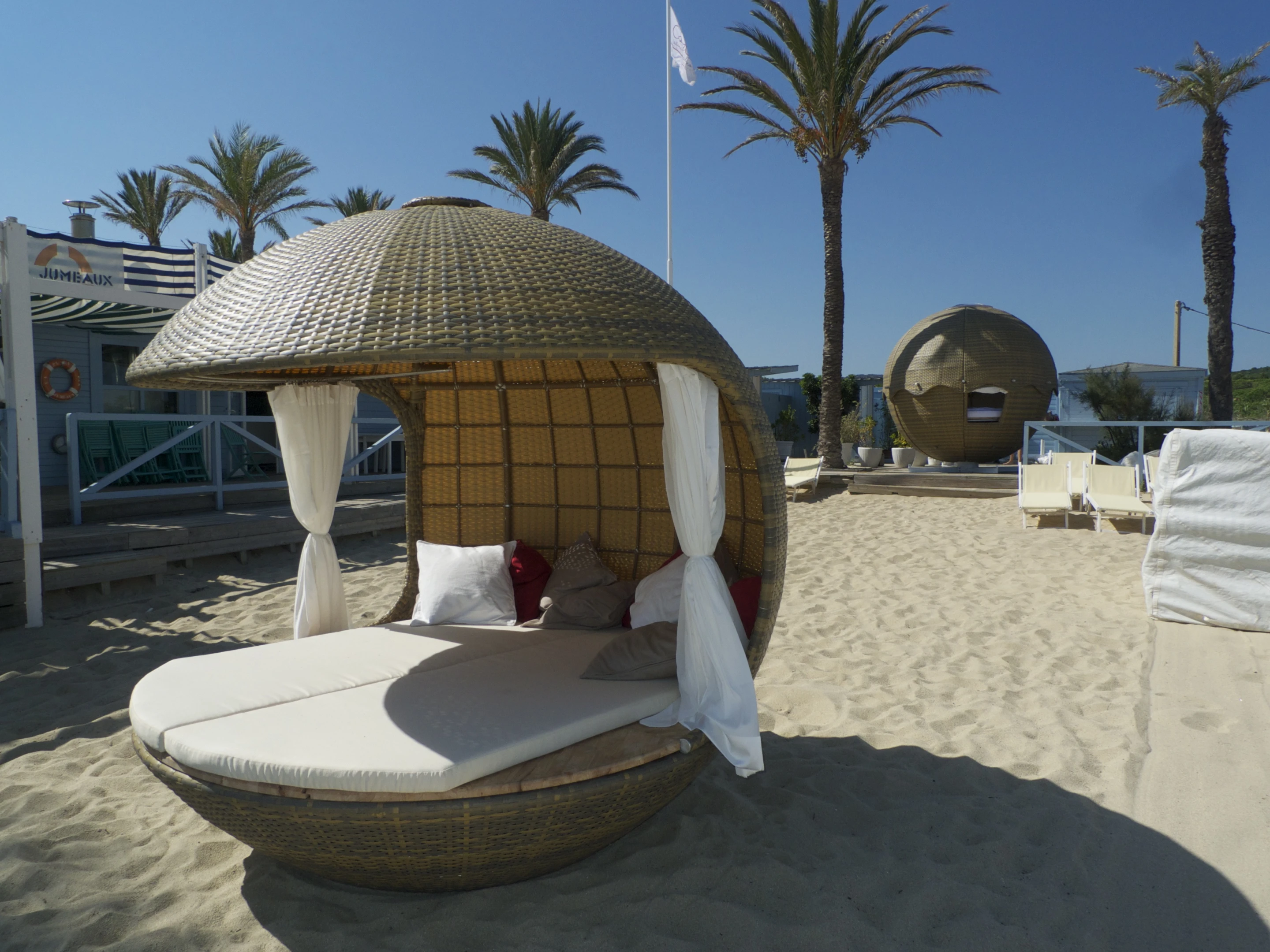 The wooden floor is home to two foam mattresses covered with a Sunbrella water-resistant fabric