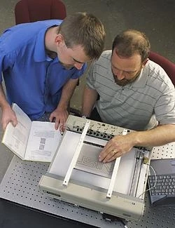 Researchers John Roberts (right) and Oliver Slattery (left) using the tactile graphic display device.