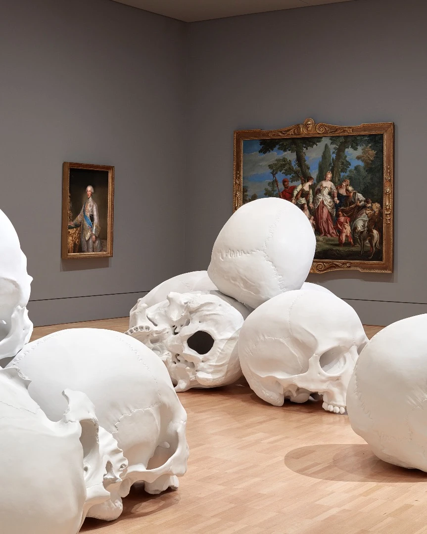 Ron Mueck's huge installation features 100 giant skulls strewn around the gallery's classic art collection