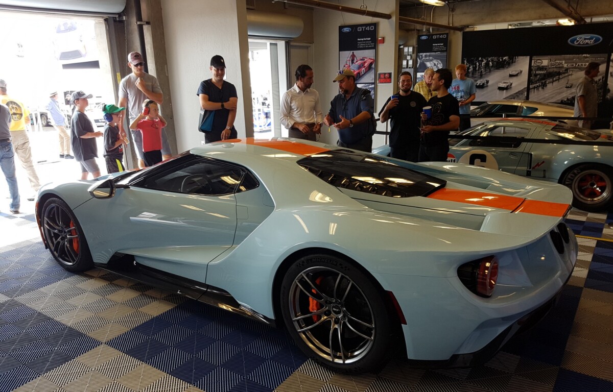 Ford unveiled the 2019 Ford GT Heritage Edition on the Paddock Stage on Friday, August 24, 2018. This is the 2019 Ford GT Heritage Edition in the pits with one of the originals in the background.