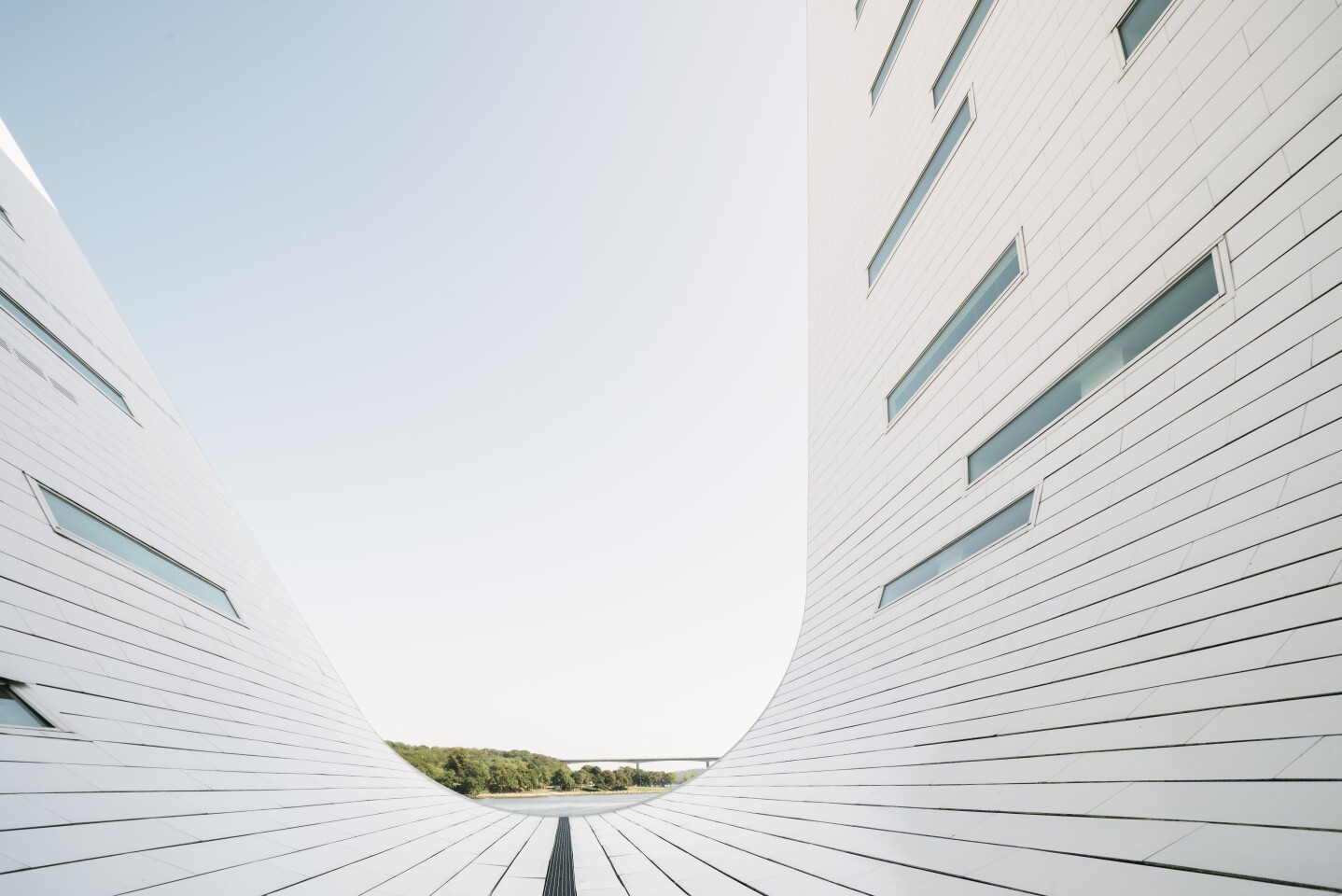 The sculpted wave-like structures that house the apartments have skylights installed to maximize light inside