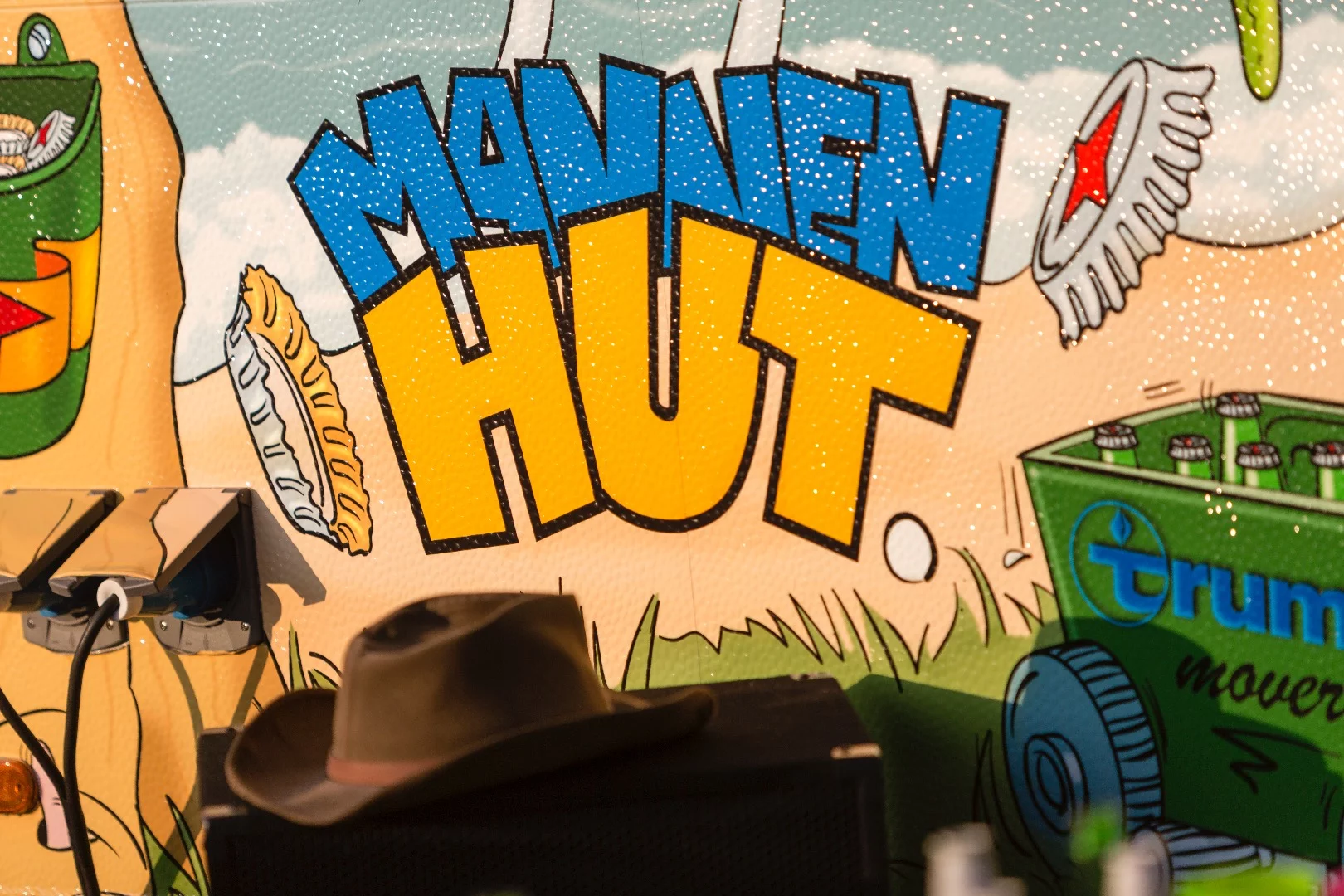 The caravan's body has colorful artwork all over