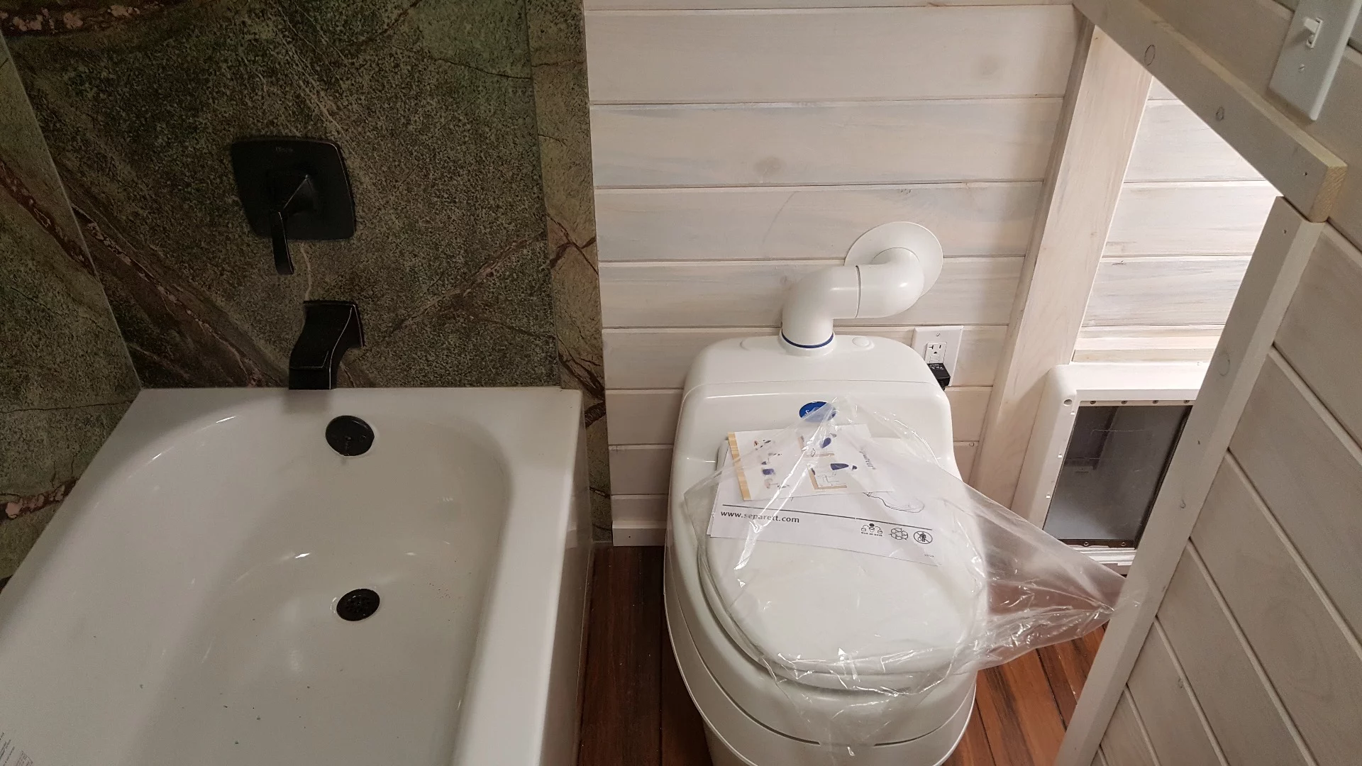 The Artist's bathroom includes a doggy door