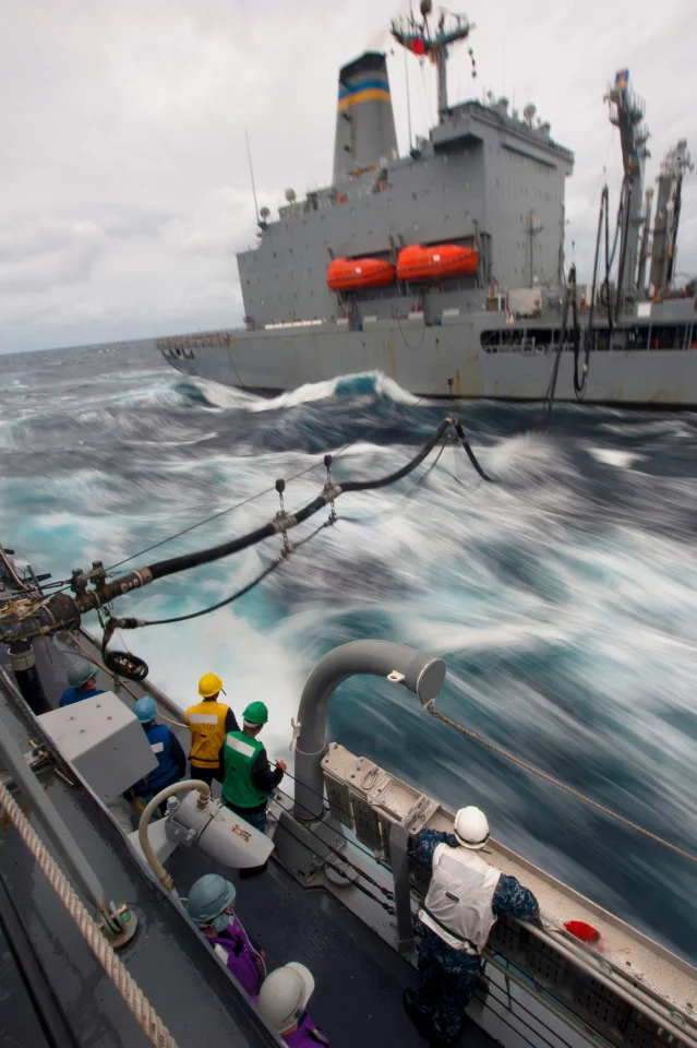 A U.S. Navy ship being refueled at sea