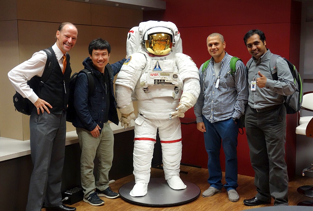 From left, Dr. John H.L. Hansen, Chengzhu Yu PhD'17, Dr. Abhijeet Sangwan and Lakshmish Kaushik pose with a model of an astronaut at the NASA Johnson Space Center in Houston