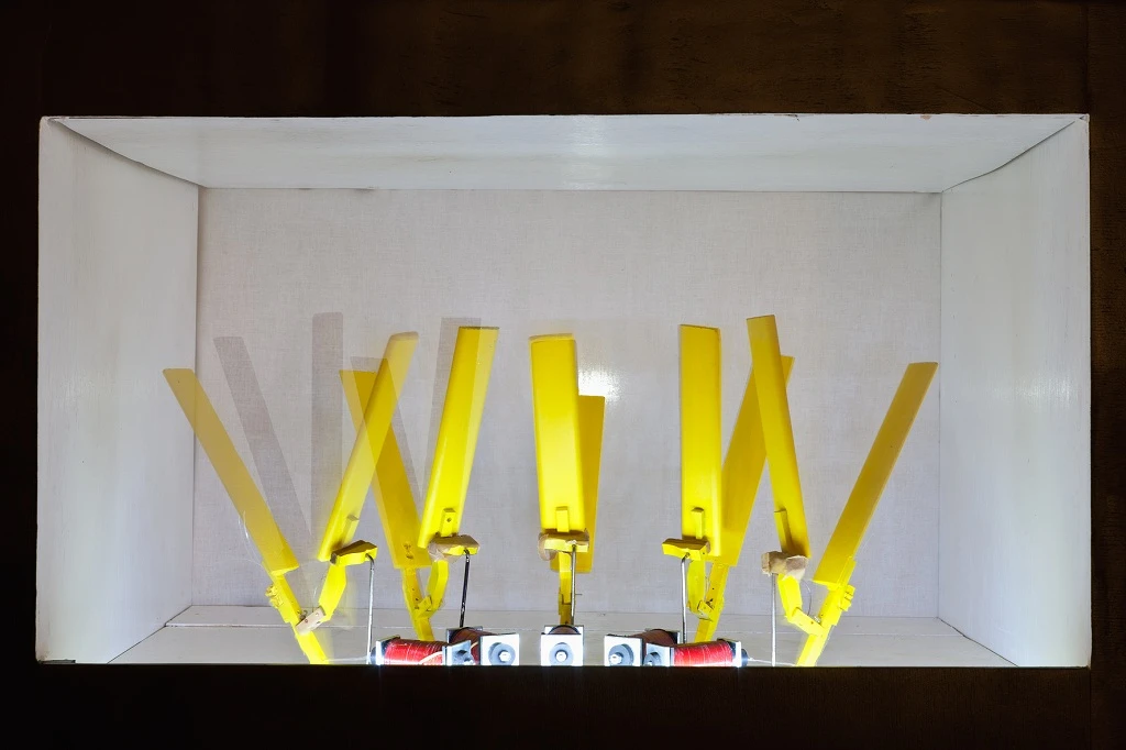 Close up of the hand clap robots placed in the MR-808's frame