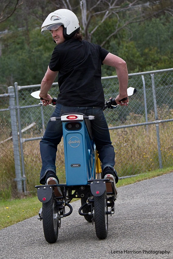 The prototype electric Deliver E-Trike has independently-pivoting rear swing arms, which allow it to stand upright when parked on grades