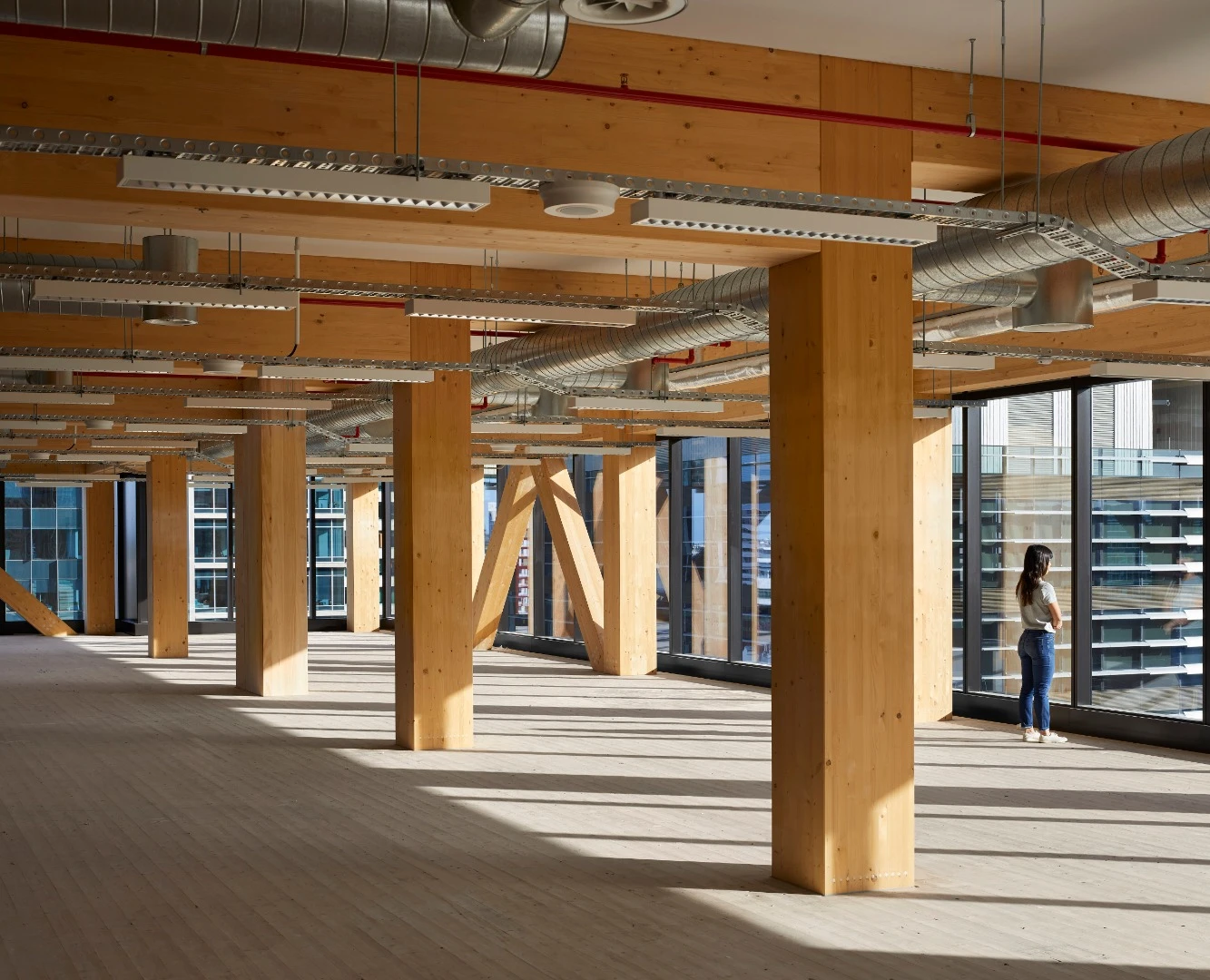 Floor-by-floor, huge exposed V-shaped columns were stacked on top of one another to support the timber slabs used for floor plates and exposed ceiling soffits inside 25 King