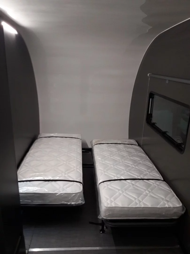 The other bedroom has two single beds