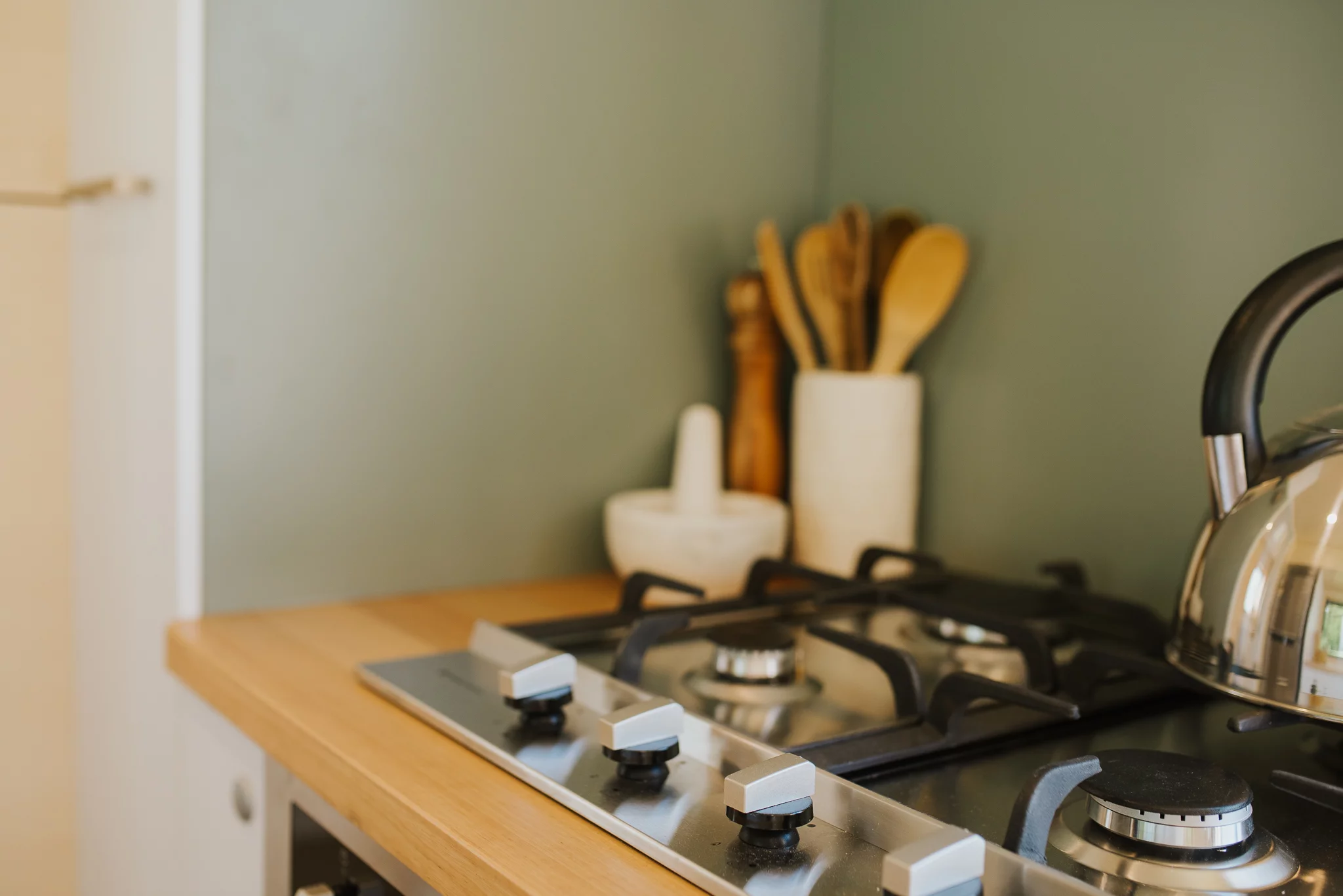 The Nugget's kitchen includes a four-burner propane-powered stove and an oven