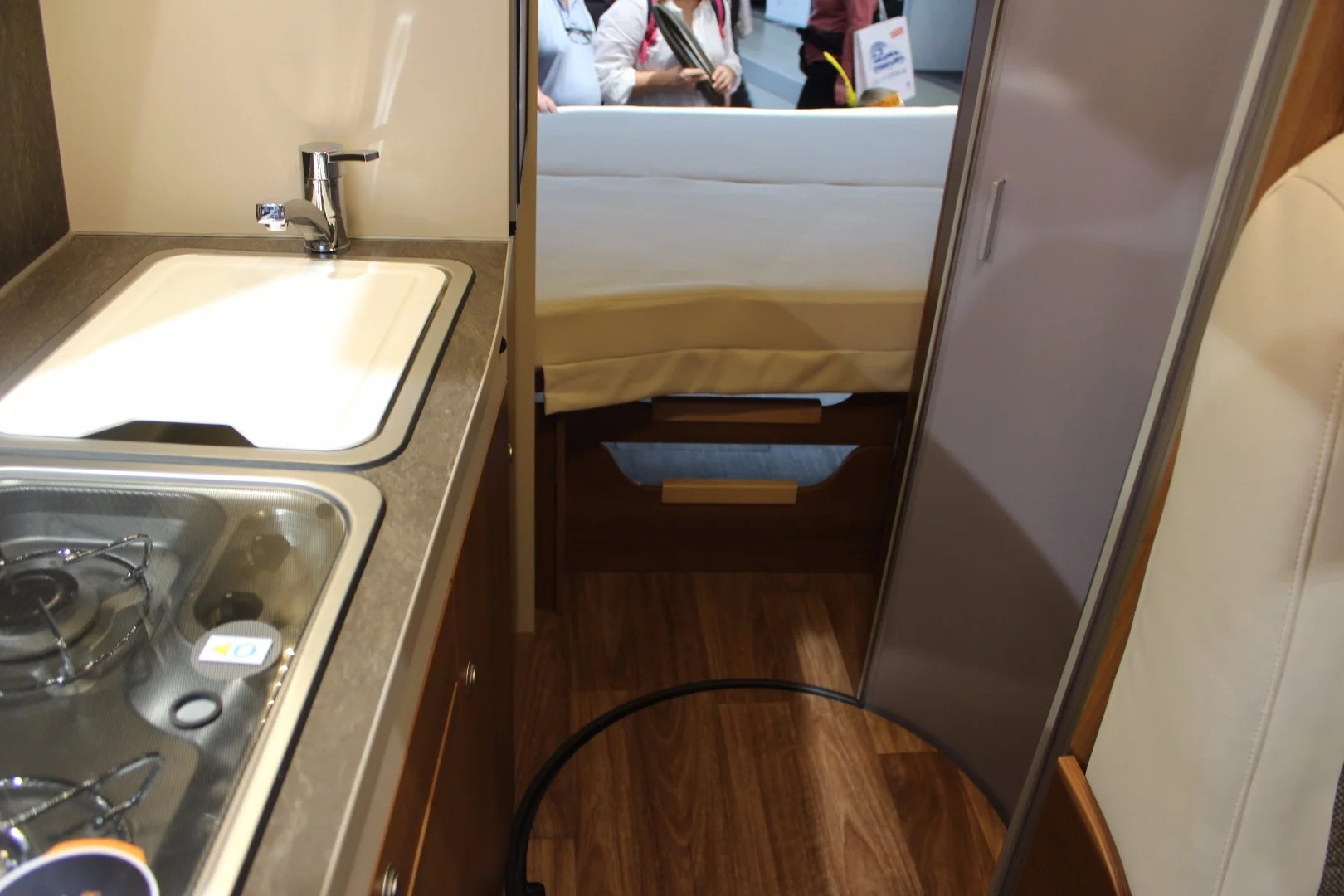 The optional en suite bathroom includes a curved sliding door that repurposes the central aisle as bathroom space