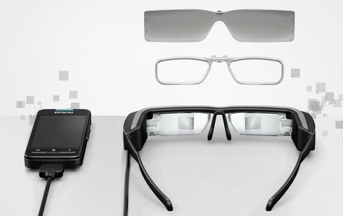 The BT-200 smart glasses come supplied with a prescription lens insert, two removable shades, some earbuds and a handheld control unit