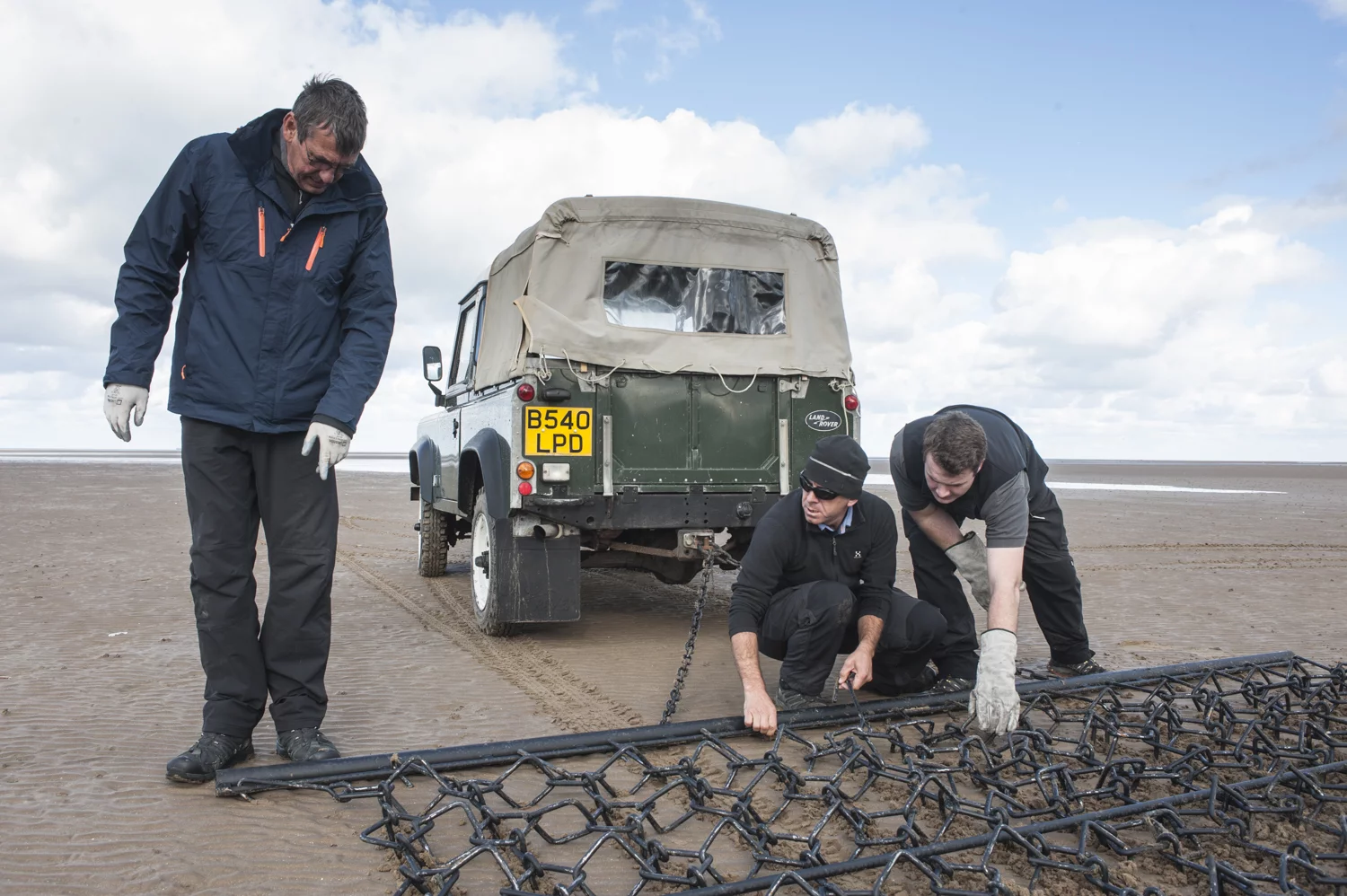 Land Rover hired Sand In Your Eye to coordinate the sand drawing. The company specializes in unique sand and ice art.