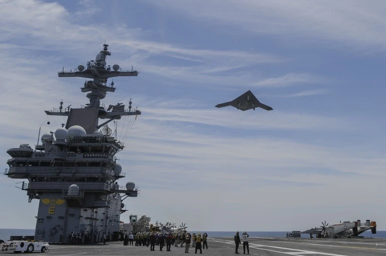 X-47B flies over the aircraft carrier USS George H.W. Bush (CVN 77) (Photo: US Navy courtesy of Northrop Grumman by Alan Radecki)
