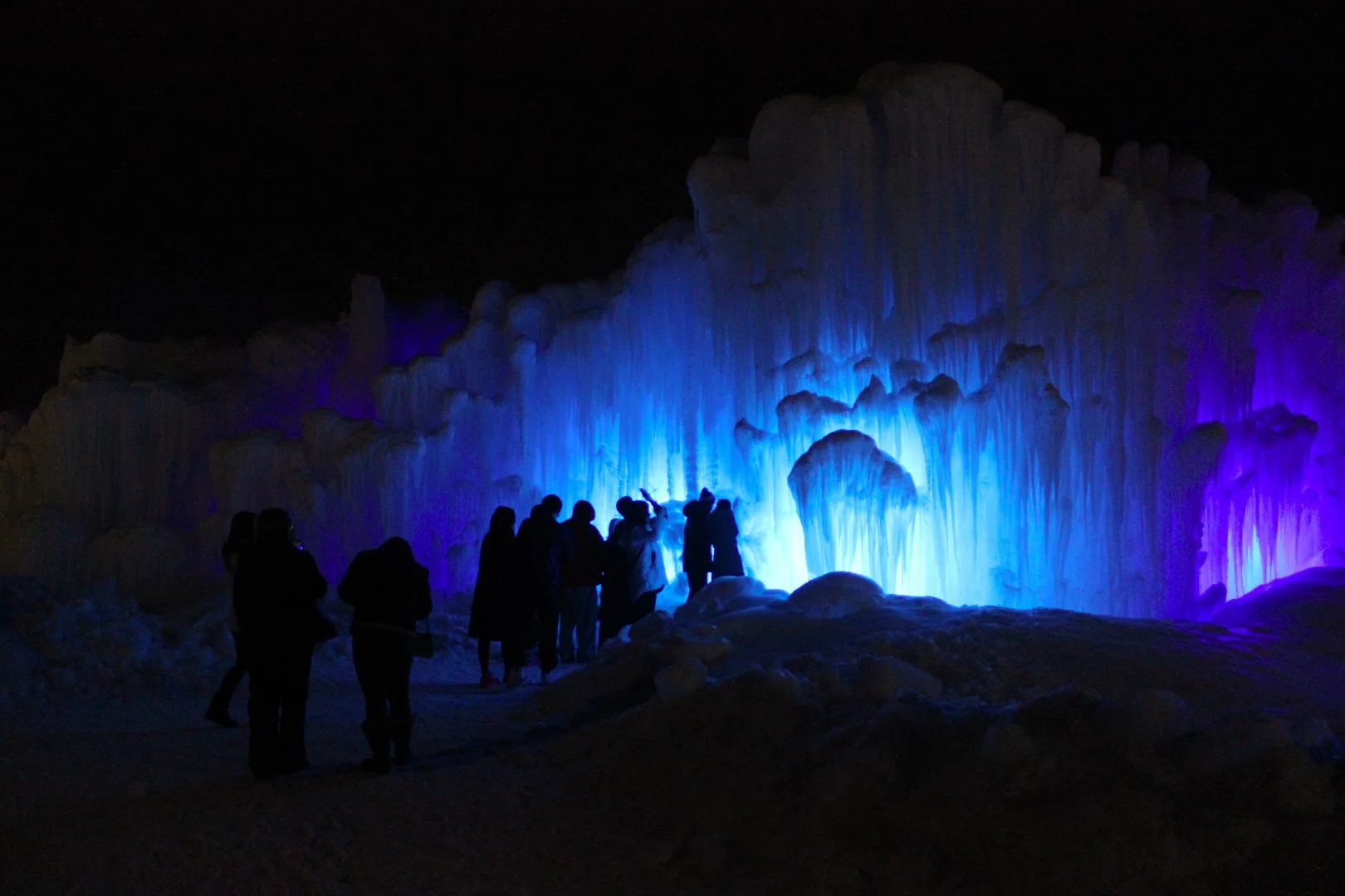 The main entrance of the Edmonton Ice Castle, lit up at night
