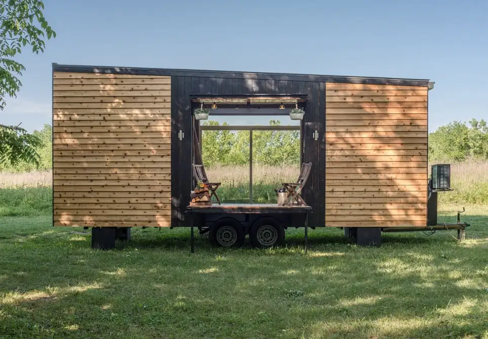 Clad in Shou Sugi Ban-treated cedar siding, the Alpha Tiny House sits on a custom double-axle trailer