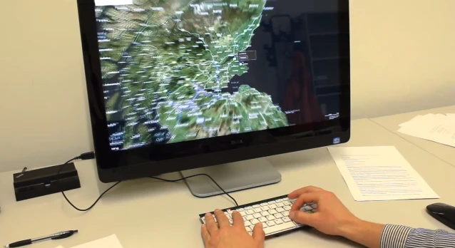 A user zooms in on a map by pinching their fingers on the keyboard