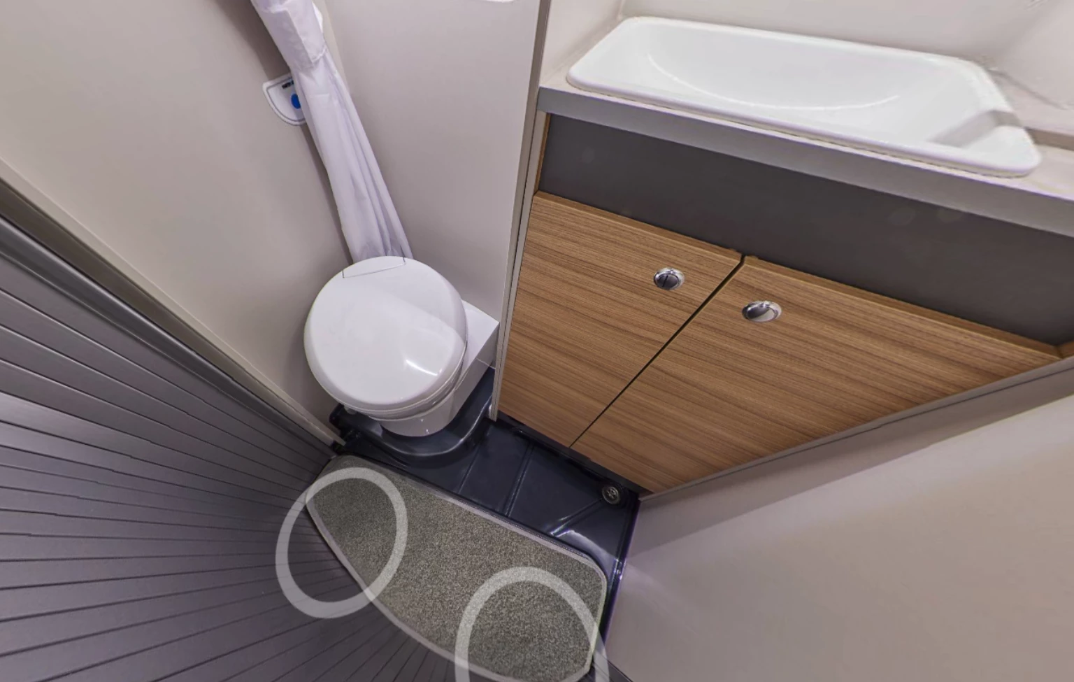 This screenshot from Bailey's 360-degree virtual tour of the standard ICE Endeavor camper shows the floor of the wet bathroom and how it expands using the roller door, which closes via the inside part of the track when the bathroom is unoccupied