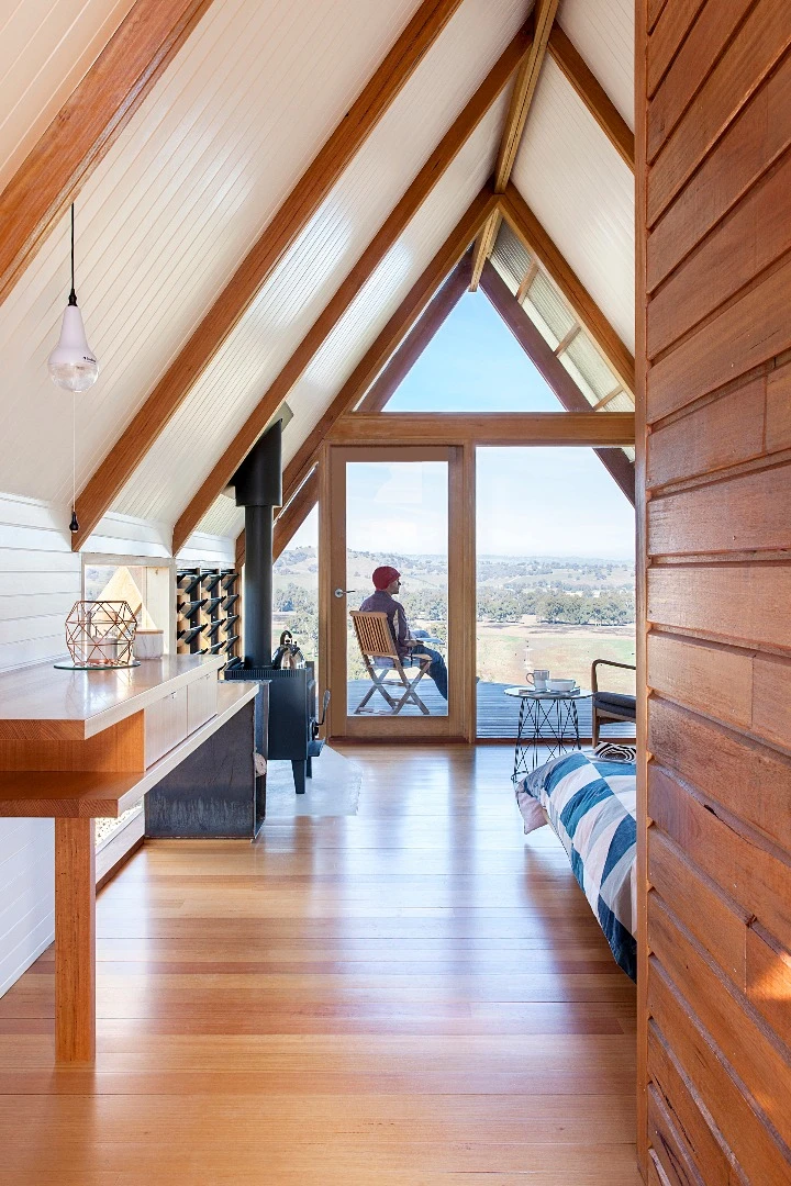 Inside the solar-powered JR's Hut is a bed for two, bathroom with a view and freestanding wood burner fireplace